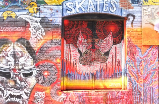 street art painting in graffiti alley, in alcove that was a window, now boarded up