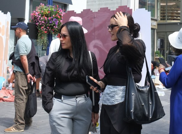two woman in Yorkville, both wearing black blouses