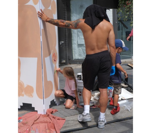 children helping to paint a mural