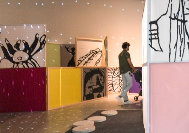 Dream Lab by Rivane Neuenschwander, a room full of drawings and coloured walls, dimly lit, with disco ball lights