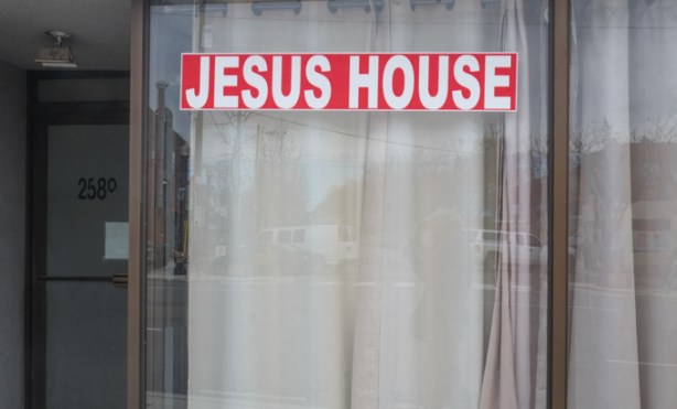 sign in store window that says Jesus House
