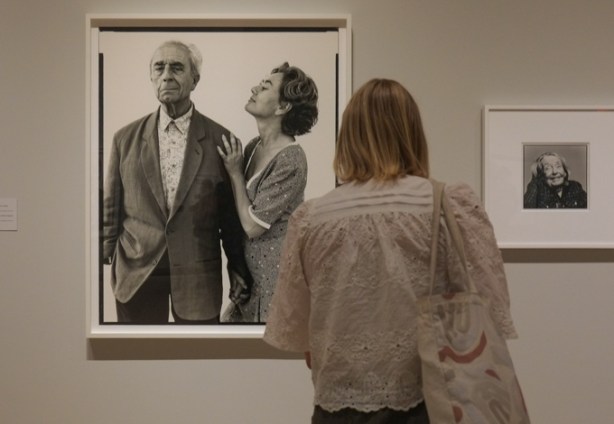 people looking at photographs in a gallery, black and white portraits by Richard Avedon