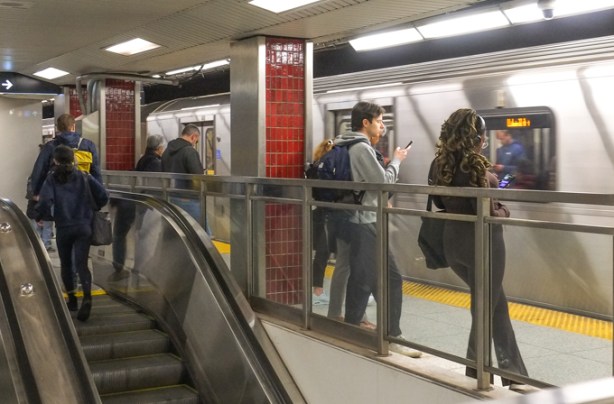 people waiting on underground LRT platform, waiting for a train