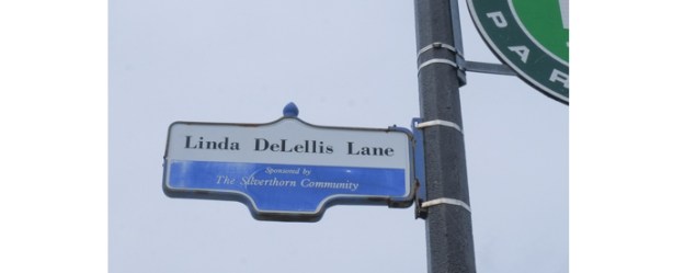 city street sign that says Linda De Lellis Lane 