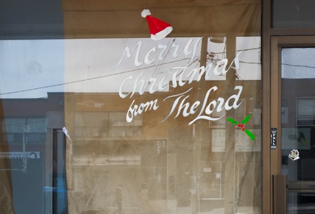 sign on store window that says Merry Christmas from the Lord