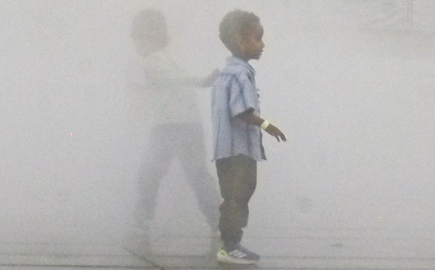 kids playing in the mist, outdoors