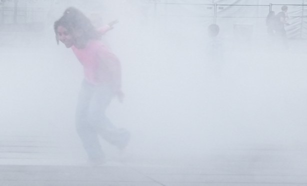kids playing in the mist, outdoors