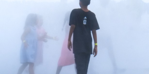 kids playing in the mist, outdoors