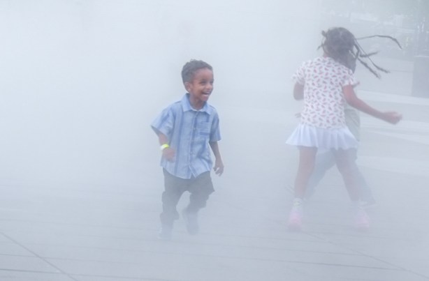 kids playing in the mist, outdoors