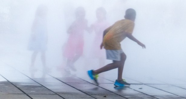 kids playing in the mist, outdoors