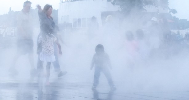 kids playing in the mist, outdoors