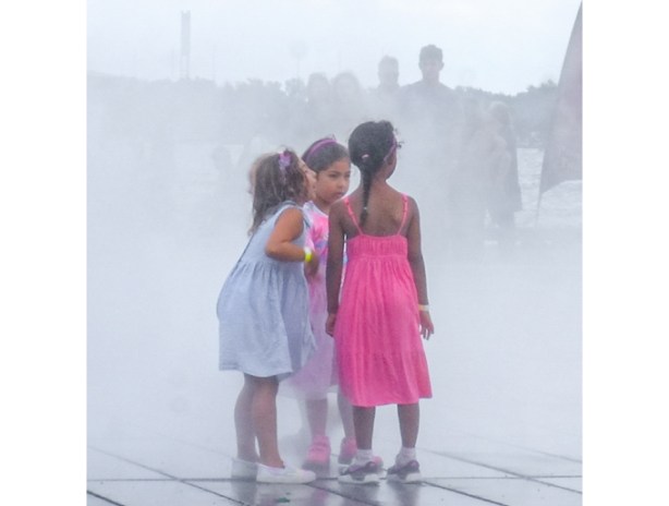 kids playing in the mist, outdoors