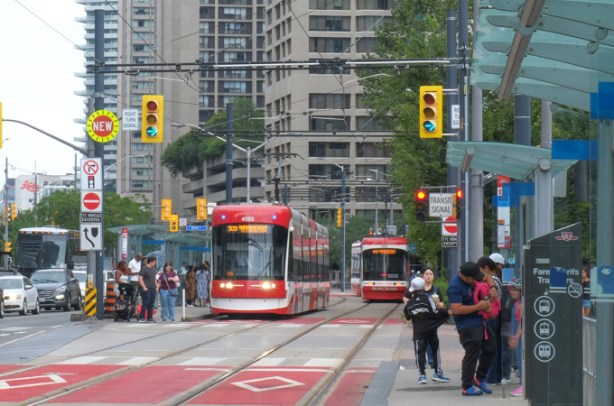 streetcars and people on Queens Quay