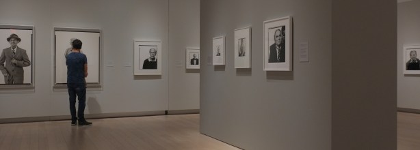 people looking at photographs in a gallery, black and white portraits by Richard Avedon