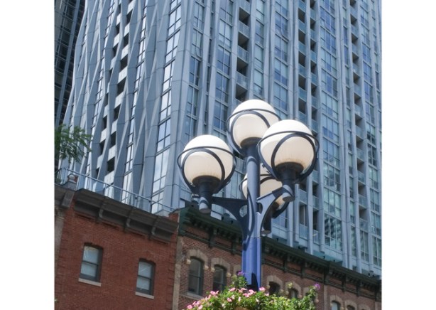 spherical shaped street lights with a tall condo building behind