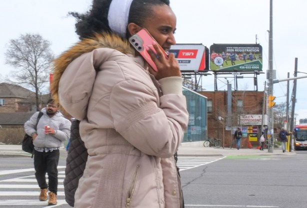 woman talking on her phone as she walks outside