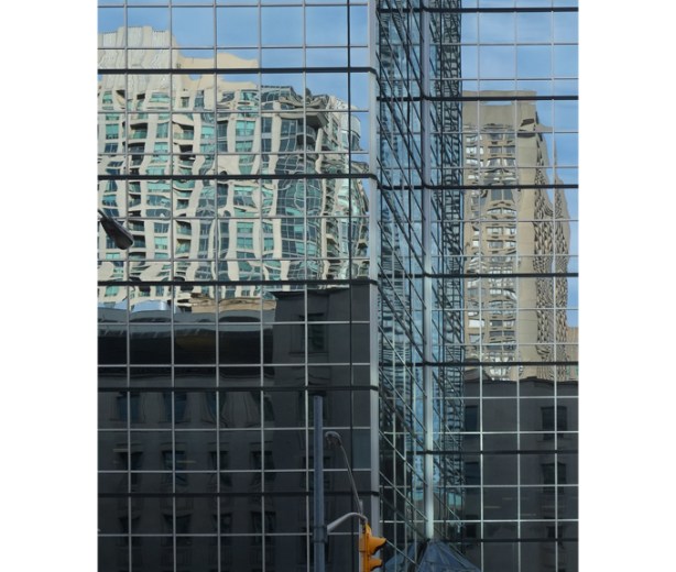reflections in tall city glass buildings