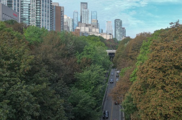 Rosedale Valley Road passes under Sherbourne Street, buildings of downtown Toronto in the distance